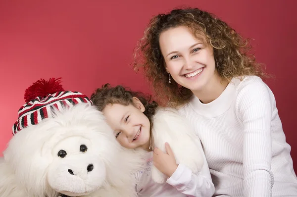 Mother and daughter smiling to the camera — Stock Photo, Image