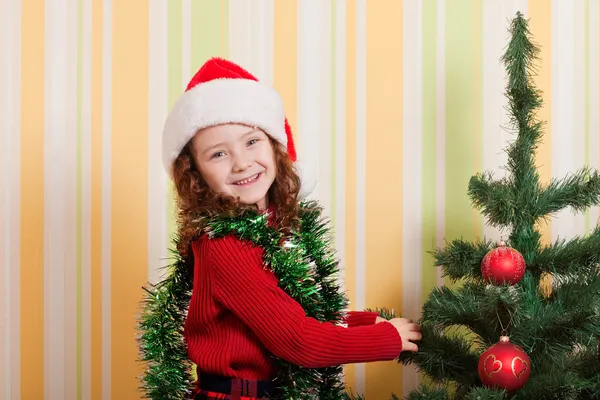 Girl decorating christmas tree — Stock Photo, Image