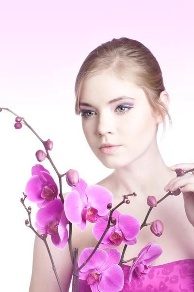 Pretty woman with orchid — Stock Photo, Image