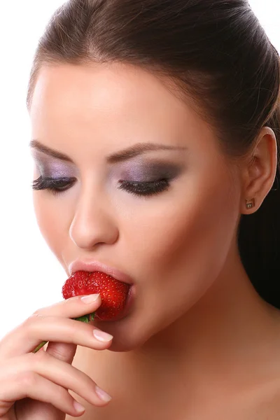 Woman eating strawberry Royalty Free Stock Images