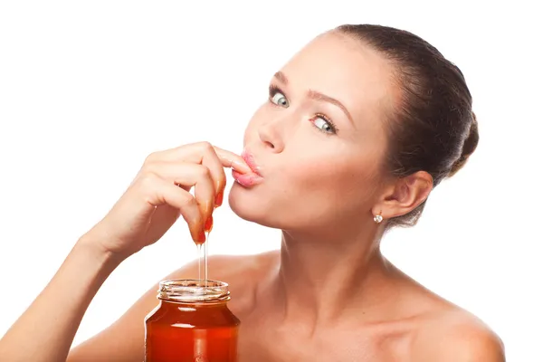 Woman eating honey — Stock Photo, Image