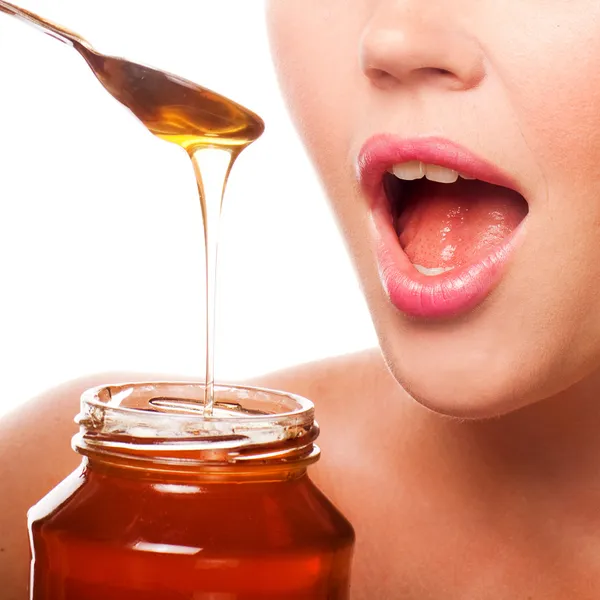 Woman with honey — Stock Photo, Image