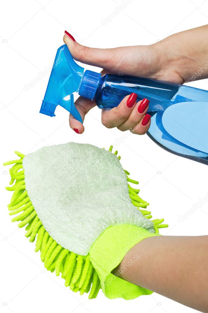 Female hand holding spray bottle and duster