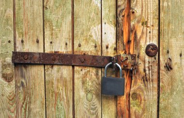 Iron bolt on wooden door with the lock clipart