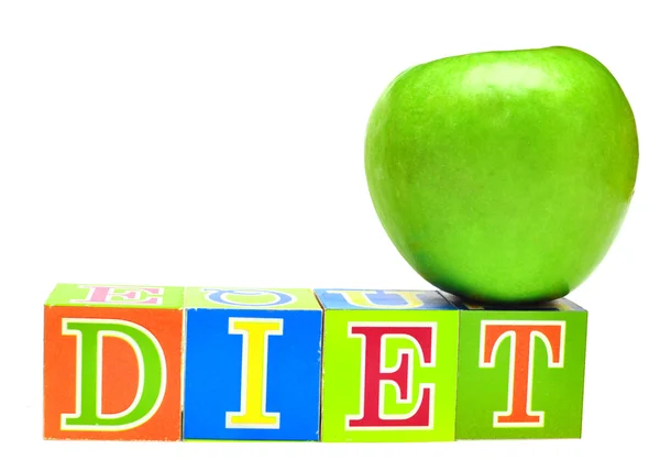 Zelené jablko a kostky s písmeny - dieta — Stock fotografie