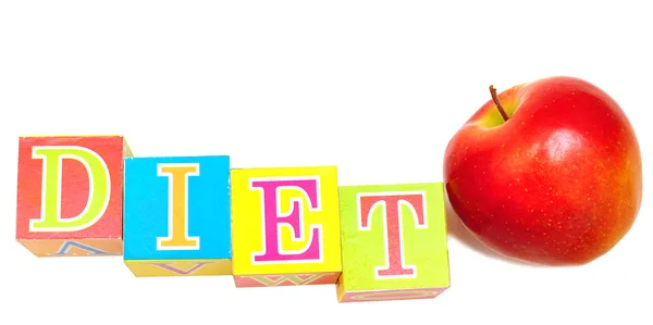 Červené jablko a kostky s písmeny - dieta — Stock fotografie