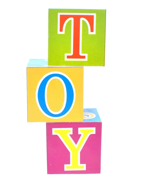 Слово іграшка написана в дитячих блоках — стокове фото