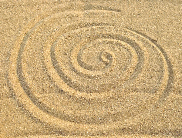 stock image Photo of spiral pattern in the sand