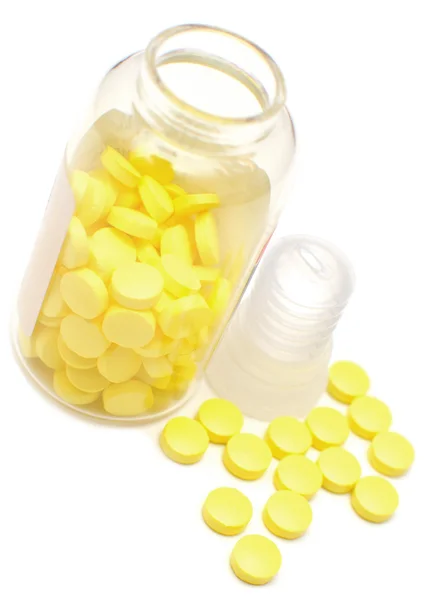 Frasco de vidrio con pastillas amarillas —  Fotos de Stock