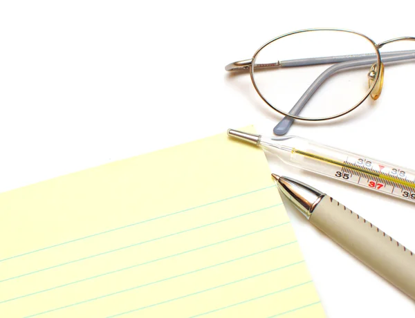 Pen, paper, thermometer, eyeglasses — Stock Photo, Image