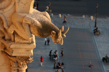 Gargoyle of Notre Dame looking down the street clipart