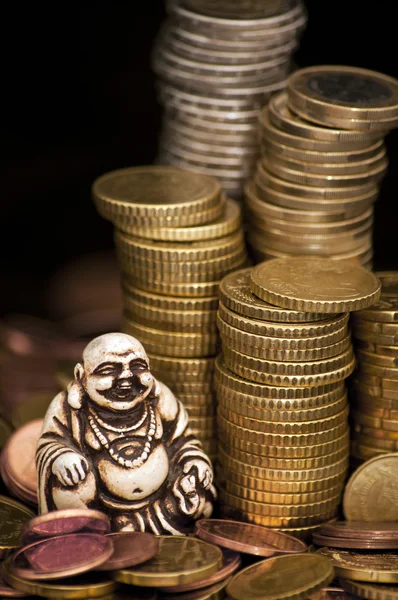 Laughing Budda in front of coins — Stock Photo, Image