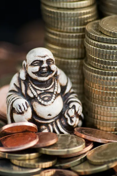 stock image Laughing Budda in front of coins