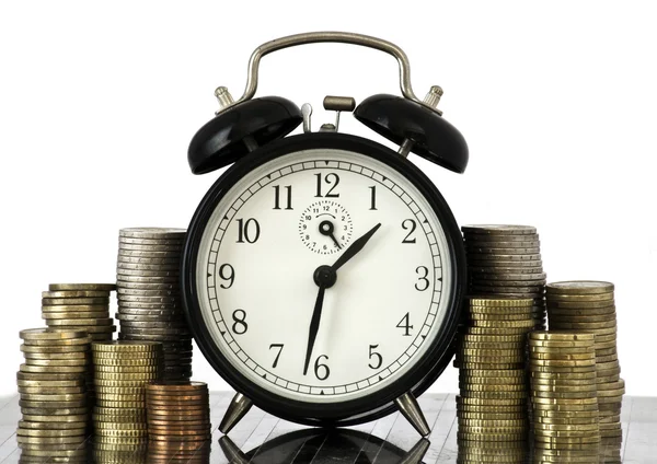 stock image TIME IS MONEY concept: alarm clock and lots of euro coins