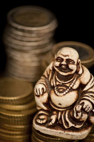 Laughing Budda in front of coins — Stock Photo, Image