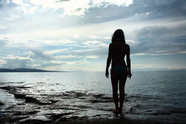 Sundown on sea,silhouette of the girl Stock Image