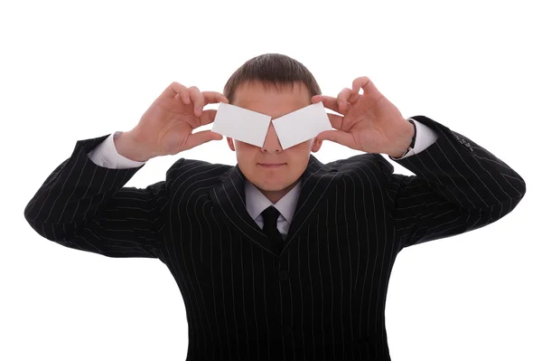 Businessman covering his eyes with business cards — Stock Photo, Image