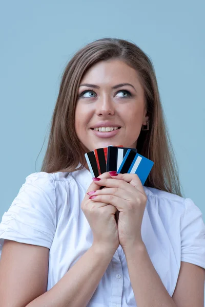 stock image Young woman holds credit cards and smiles