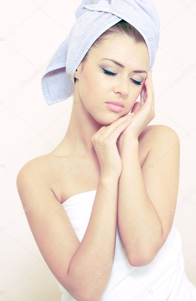 Young woman sits turned in a bedsheet — Stock Photo © vitmihailov #3723880