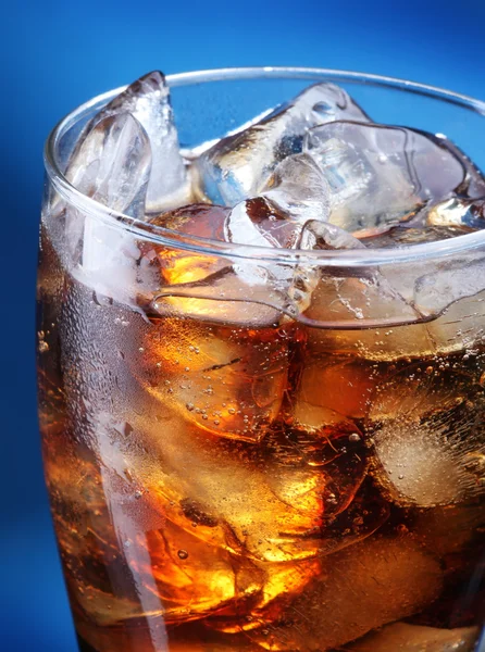 Glass of ice cola on a blue background — Stock Photo, Image
