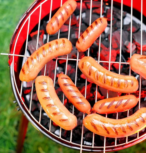 Fried sausages on a grill — Stock Photo, Image