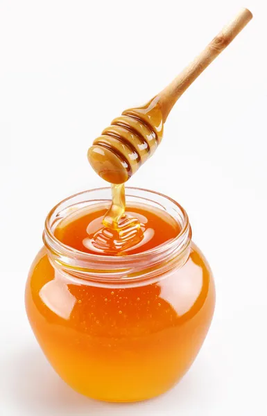 Panela de mel completa e pau de mel — Fotografia de Stock