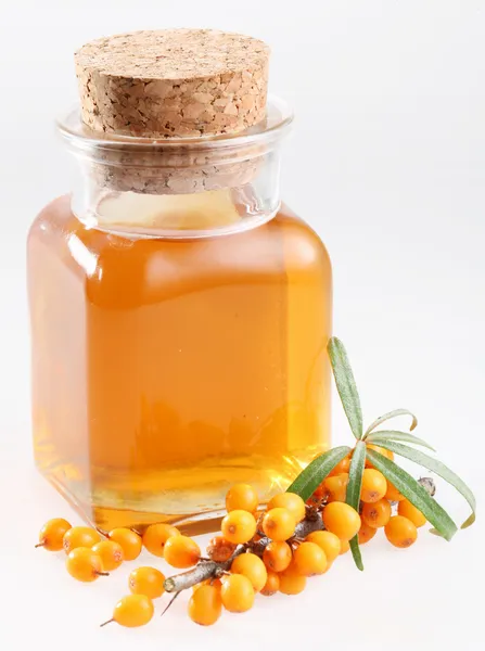 Sea buckthorn oil on a white background — Stock Photo, Image