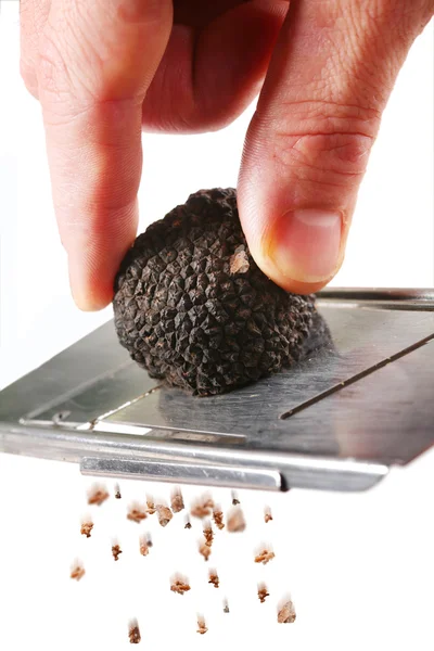 Stock image The mushroom of truffle is ground on a grater on a white background