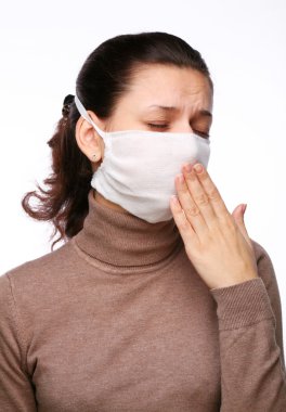 Coughing woman in a medical mask on a white background clipart