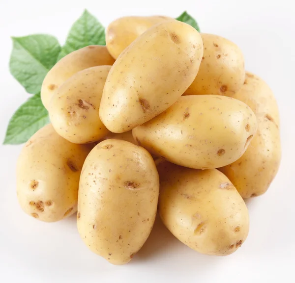 Žluté brambory s listy na bílém pozadí — Stock fotografie