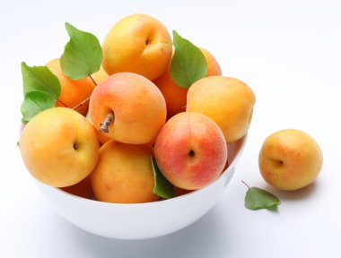 Crockery with mellow apricots. clipart