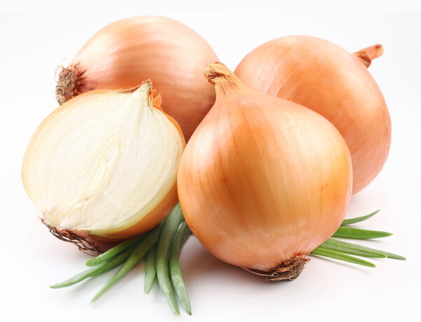 Fresh bulbs of onion on a white background