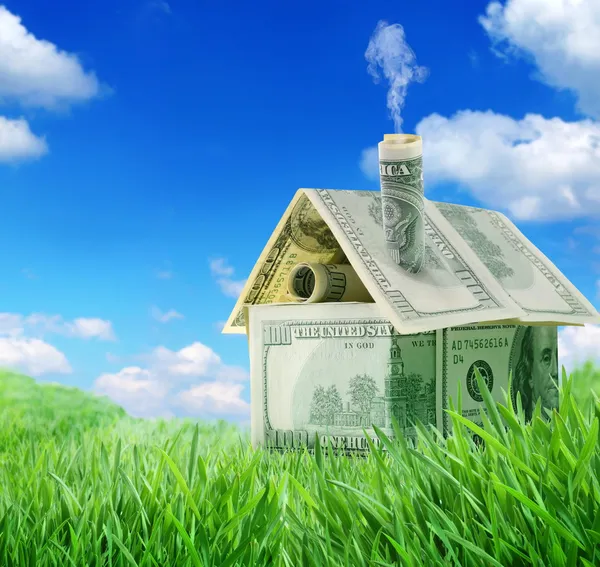 Δολάριο σπίτι σε ένα πεδίο πράσινο γρασίδι πάνω από το γαλάζιο του ουρανού — Φωτογραφία Αρχείου