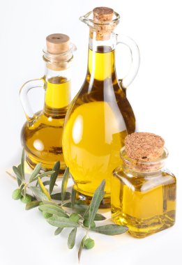 Branch with olives and a bottles of olive oil isolated on white clipart