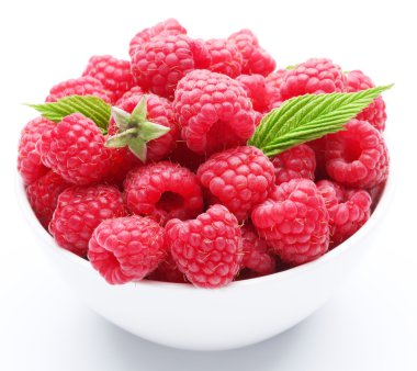 Crockery with beautiful tempting raspberries. Isolated on white clipart