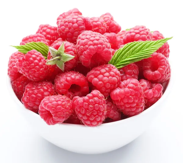 Crockery with beautiful tempting raspberries. Isolated on white — Stock Photo, Image