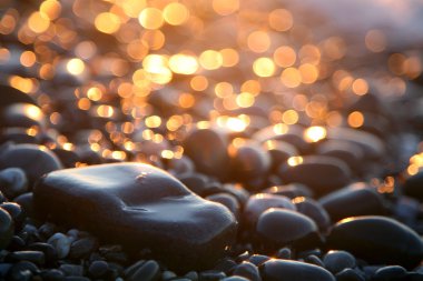 Background with sea stones and orange blurred circles. clipart