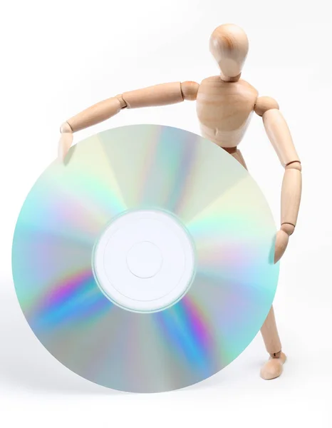 Dřevěný muž držící velkého počítače disk — Stock fotografie