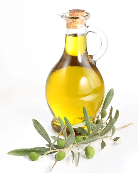 Branch with olives and a bottle of olive oil isolated on white — Stock Photo, Image