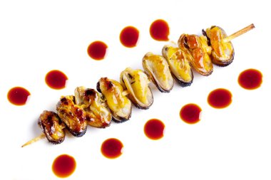 Fried mussels on wooden stick clipart