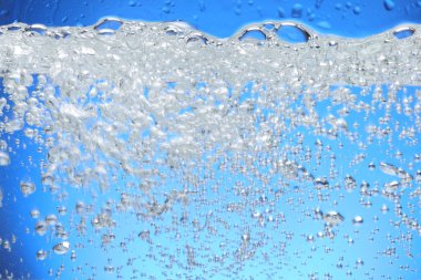 Air bubbles rise from the water surface. clipart