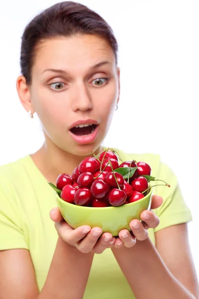 Woman with crockery of cherries in her hands. — Stock Photo, Image