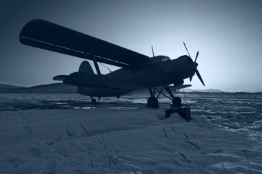 The dark blue plane on snow clipart