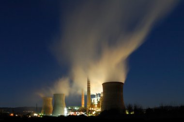 Power plant under a dusky blue sky clipart