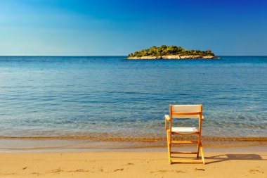 Chair on sandy beach clipart