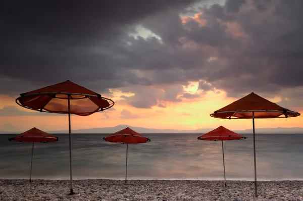 Beach umbrellas on a windy day — Stock Photo, Image