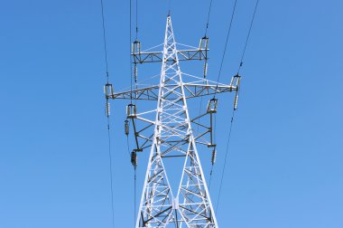 Electric high voltage post with blue sky background clipart