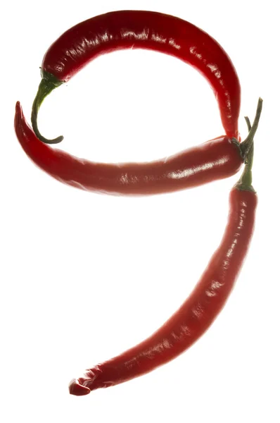 Αριθμός «9» κατασκευασμένο από πιπεριές τσίλι σε άσπρο φόντο — Φωτογραφία Αρχείου
