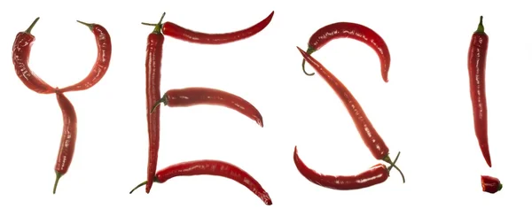 Pimentas vermelhas de malagueta soletrando a palavra "sim!" horizontalmente — Fotografia de Stock