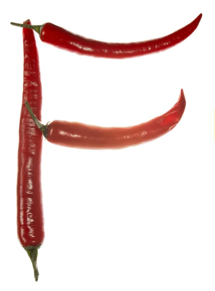 "F "dopis vyrobený z chilli papriček na bílém pozadí — Stock fotografie